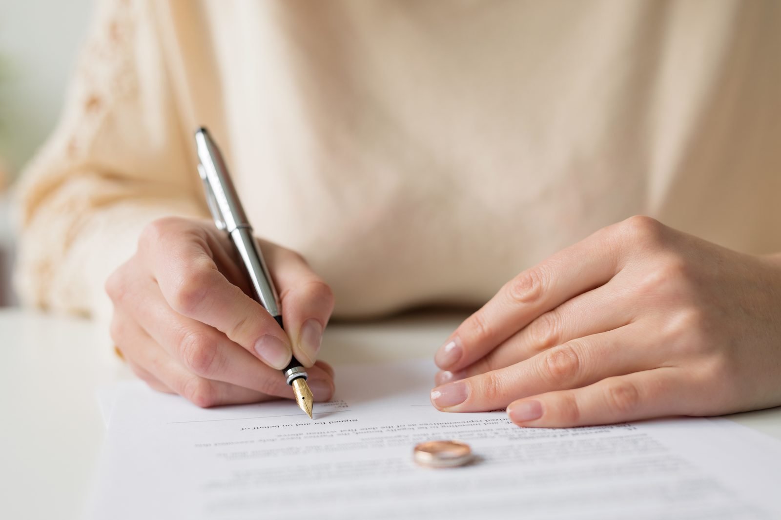 woman signing divorce papers Florida home sale