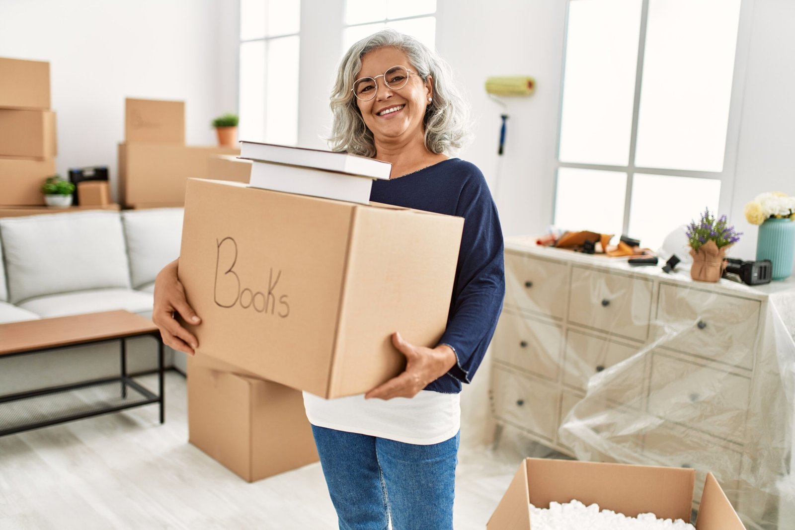 downsizing in Tampa Bay woman moving boxes new home